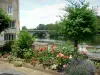 Parcé-sur-Sarthe - Old mill, flowerbeds, tree and bridge spanning over River Sarthe