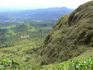 Pelée mountain - View parking spoiler and the surrounding green landscape from the hiking trail to the summit of the volcano