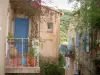 Pigna - Small balcony decorated with plants and houses of the village (in the Balagne region)