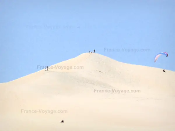 Pilat dune - Paraglider flying over the highest dune in Europe located in the town of La Teste-de-Buch 