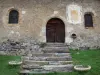 Plampinet - Facade of the Romanesque Saint-Sébastien church featuring a painted sundial; in the Clarée valley