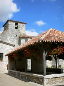 Pujols - Covered market hall with flowers and bell tower of the Saint-Nicolas church