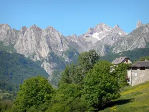 Pyrenees National Park - Aspe valley: houses overlooking the cirque rock formations of Lescun
