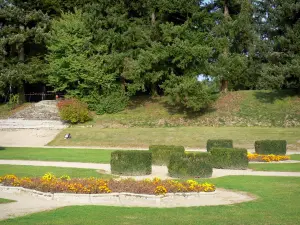 Ravel castle - French-style formal garden with its flowerbeds, shrubs and lawns, trees in the background