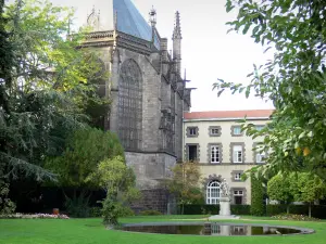 Riom - Holy Chapel of Gothic style, remains of the palace of the Duke of Berry, and garden of the court of appeal with the statue of Michel de l'Hospital, expanse of water, lawns and trees