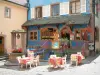 Riquewihr - Flower-bedecked well, restaurant terrace and blue house