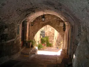 Roquebrune-Cap-Martin - Beautiful stone arched passage, plants and flowers in background