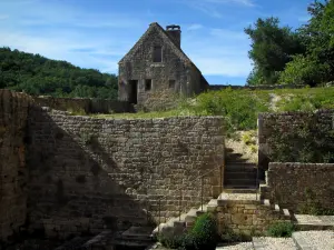 Saint-Amand-de-Coly - MURALLAS (paredes) de la iglesia de la abadía y casa de piedra en el Périgord