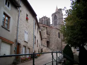 Saint-Bonnet-le-Château - Bell towers of the collegiate church, paved sloping street, tree, shrubs, flowers and houses of the old town