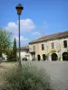 Saint-Clar - Place de la République square (arcaded square): arcaded houses, lamppost and lavender