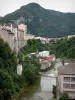 Saint-Claude - Bridge spanning the river, trees along the water, houses and buildings of the city, and mountain; in the Upper Jura Regional Nature Park