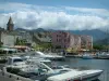 Saint-Florent - Marina with boats, church bell tower and houses of the seaside resort