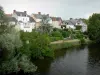 Saint-Gaultier - Facades of houses overlooking the river Creuse and trees along the water; in the Creuse valley