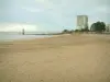 Saint-Nazaire - Sandy beach, lighthouse, sea (Atlantic Ocean), building and cloudy sky