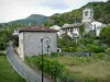 Saint-Nazaire-en-Royans - Vercors Regional Nature Park: road lined with houses and Romanesque belfry of the Saint-Nazaire church overlooking the whole area