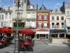 Saint-Quentin - Cafe terrace, flower-bedecked fountain, shops and facades of houses in the Rue Croix Belle Porte street