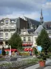 Saint-Quentin - Flower beds, potted shrubs and facades of the Place de l'Hotel de Ville square; bell tower of the Saint-Quentin basilica