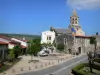 Saint-Saturnin - Octagonal bell tower with two floors of the Romanesque church of Saint-Saturnin, fountain and houses of the medieval village; in the Auvergne Volcanic Regional Nature Park