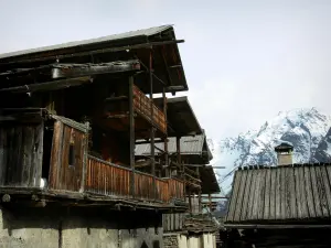 Saint-Véran - Traditional houses of the mountain village and snowy mountain (snow)
