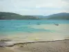 Sainte-Croix lake - Beach, emerald-coloured lake (water reservoir), windsurfing boards and boats on the water,  hills; in the Verdon Regional Nature Park