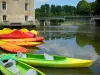 Sarthe valley - Moored canoes and pedal boats, mill of Malicorne-sur-Sarthe, and bridge spanninf over River Sarthe