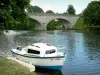 Sarthe valley - Moored boat and Solesmes bridge spanning over River Sarthe