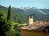 Séguret - Roof of a house with view of the forest and the peaks of the Dentelles de Montmirail