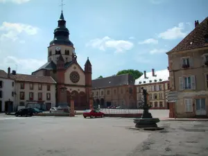 Senones - Square with a fountain, houses, church and an ancient abbey, clouds in the sky