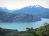 Serre-Ponçon lake - Water reservoir (artificial lake) surrounded by mountains with snowy tops (snow)