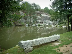 Sidobre - Shore with a bench, the Merle lake, cliffs and trees in the Upper Languedoc Regional Nature Park