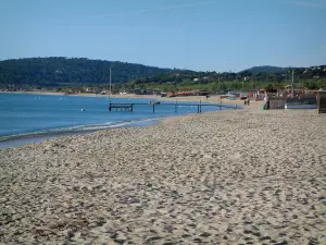 Spiaggia di Pampelonne - Baia di Pampelonne a Ramatuelle: spiaggia di sabbia, Mar Mediterraneo, un pontone e le colline boscose