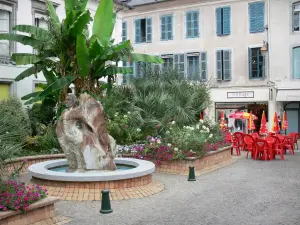 Tarbes - Square with a fountain, flowers and shrubs, café terrace and facades of houses