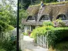 Thatched Cottage Route - Half-timbered house with a thatched roof, and its flower garden; in Vieux-Port, in the Norman Seine River Meanders Regional Nature Park
