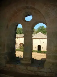 Thoronet abbey - Cistercian abbey of Provençal Romanesque style: column of the cloister with view of the hexagonal pavilion
