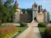 Thoury castle - Driveway lined with flowers and shrubs leading to the castle; in the town of Saint-Pourçain-sur-Besbre, in Besbre valley