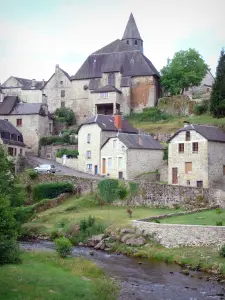 Treignac - Bell tower of the Notre-Dame-des-Bans and houses of the low city overlooking the river Vézère