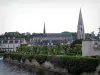 Vendôme - The Trinité Abbey church of and its isolated Romanesque bell tower (Trinité abbey), ruin of the feudal castle in background, houses of the old town, trees and the Loir River