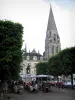 Vendôme - Clocher roman de l'abbaye de la Trinité et place Saint-Martin avec terrasse de café, statue de Rochambeau et arbres