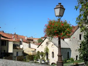 Verteuil-sur-Charente - Lamppost decorated with flowers, water mill and houses of the village; in the Charente valley