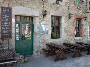 Villedieu-les-Poêles - Terrasse eines Restaurants und Fassade eines Hauses aus Stein