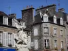 Villedieu-les-Poêles - Statue in foreground and houses of the town of copper (old town)