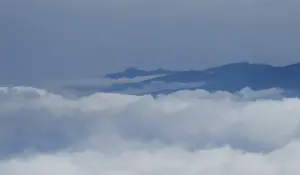 From road ridges, views of the peaks retaining the clouds