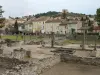 Roman ruins with the village and the castle in the background
