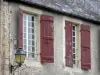 穆兰昂吉尔贝尔 - 一个房子的门面有墙壁灯笼和窗口的与红色快门