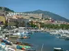 Ajaccio - Port de pêche et de plaisance avec  bateaux, quais, palmiers, maisons hautes de la vieille ville, immeubles et colline en arrière-plan
