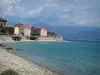 Ajácio - Praia de cascalho, mar Mediterrâneo, cidadela e cidade velha, colinas ao fundo