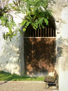 Aubeterre-сюр-Dronne - Дверь монолитной церкви Святого Иоанна (подземная церковь) и скамейки