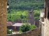 Autoire - Toren van de kerk, dorp huizen en bomen, in de Quercy