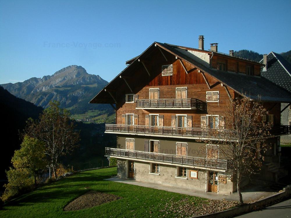Guide d'Auvergne-Rhône-Alpes - Châtel - Chalet en bois, jardin, arbres et montagne en arrière-plan, dans le Chablais