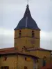 Bagnols - Stone house and church bell tower in the village in the Pierres Dorées (golden stones) area